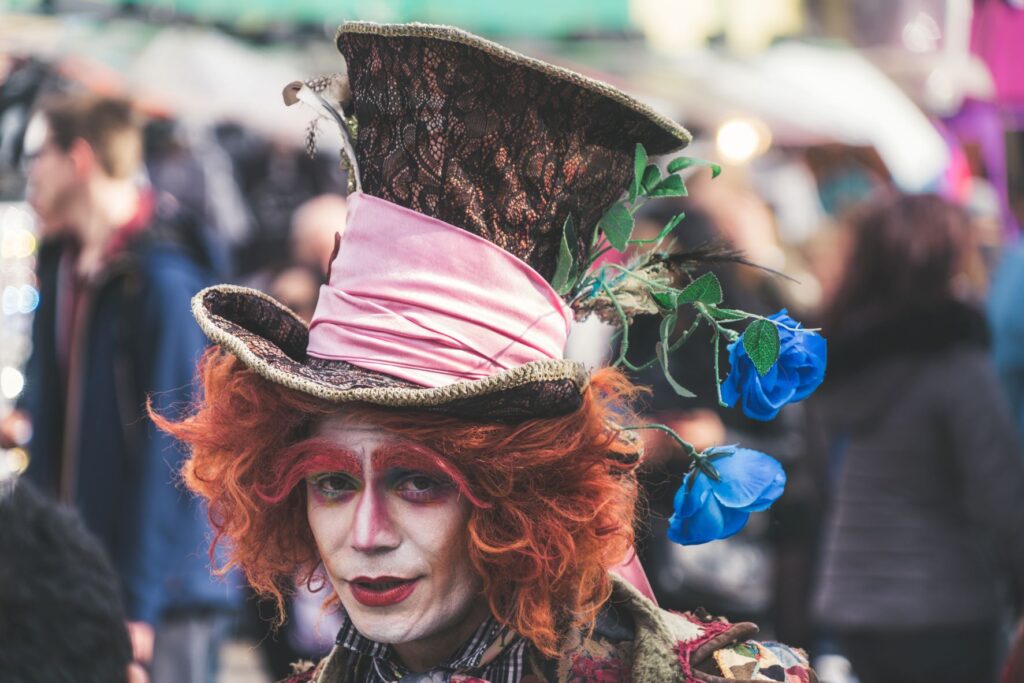 Mad Hatter looking red haired man with blue flowers in his hat